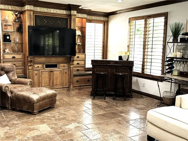 a living room with furniture fireplace and window
