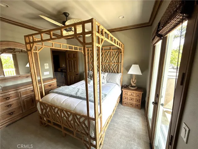 a bedroom with a bed and glass walk in closet