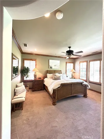 a spacious bedroom with a bed and a large window