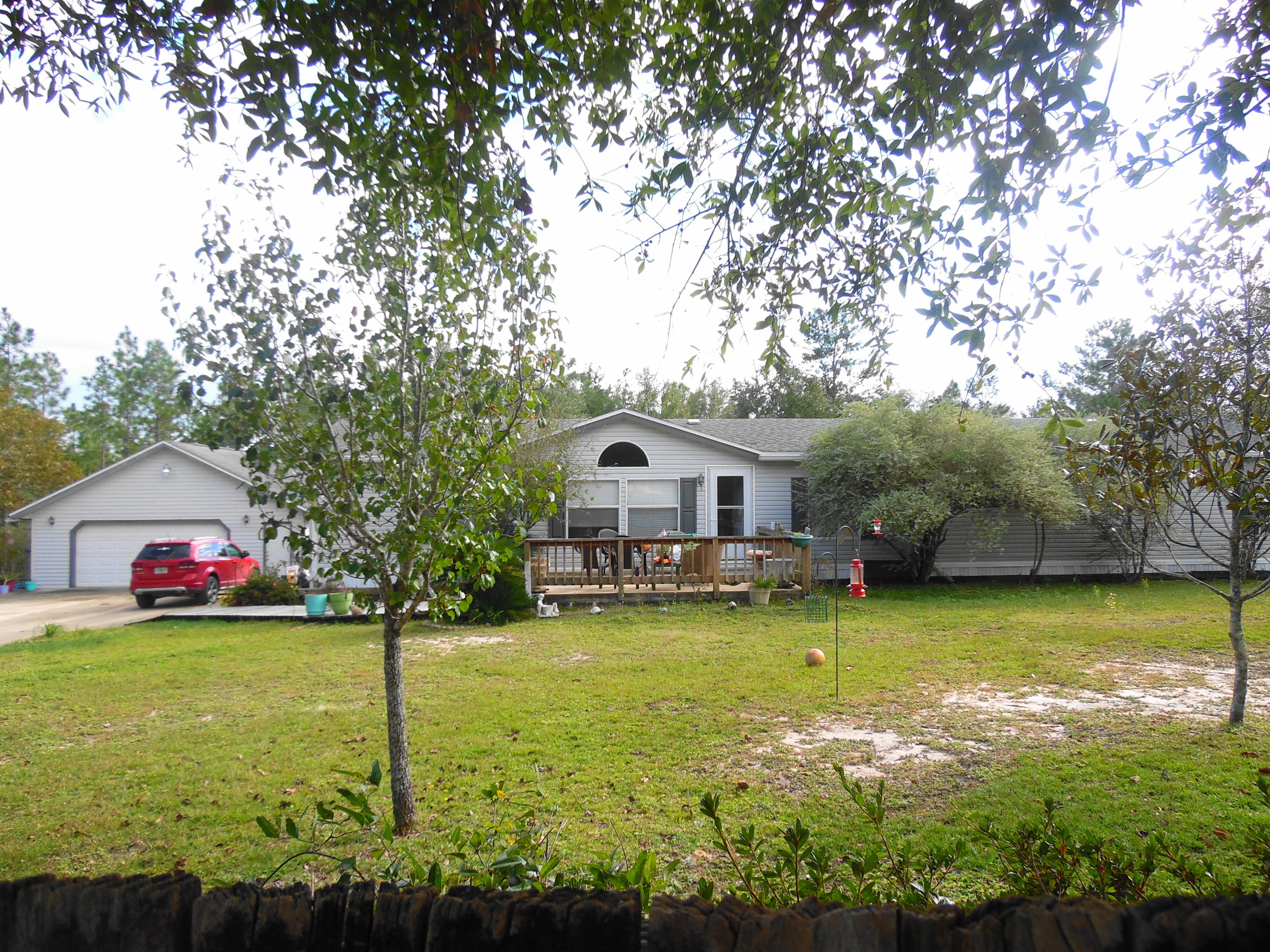 642 Elmwood Road DeFuniak Springs, FL 32433 - Photo 1 of 37 a view of a house with swimming pool and a yard
