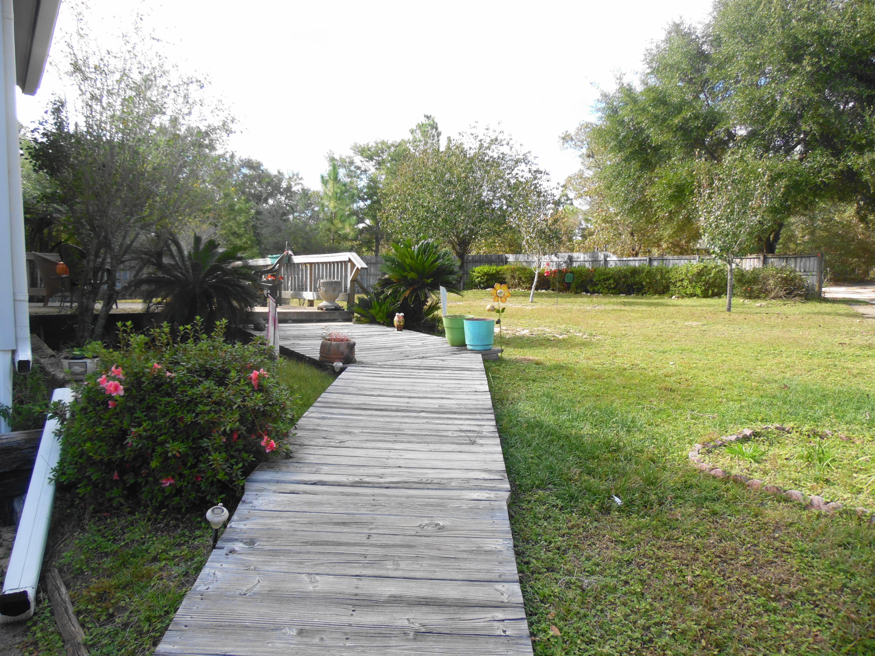 642 Elmwood Road DeFuniak Springs, FL 32433 - Photo 16 of 37 a view of a garden with houses
