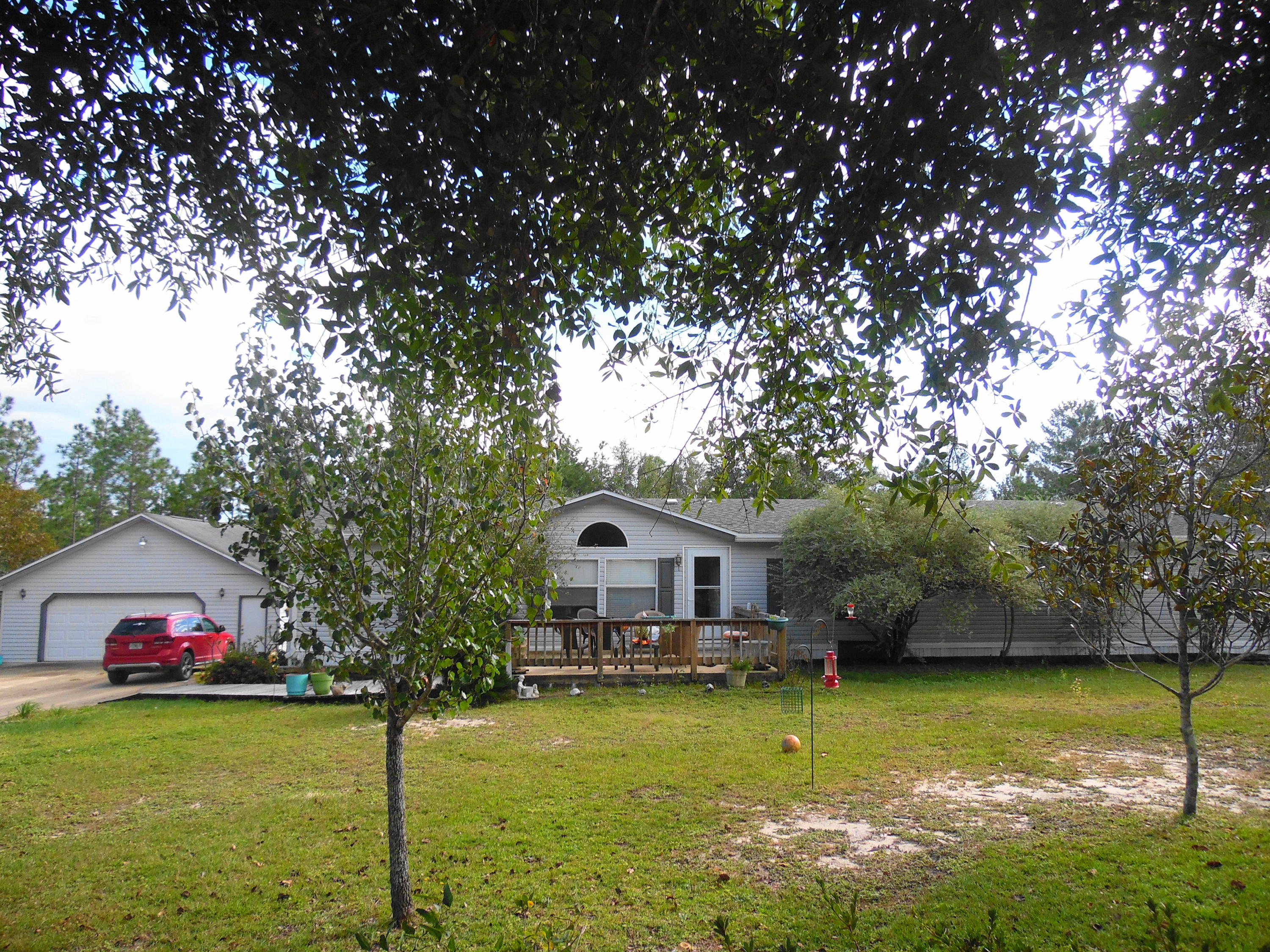 642 Elmwood Road DeFuniak Springs, FL 32433 - Photo 2 of 37 a front view of a house with garden