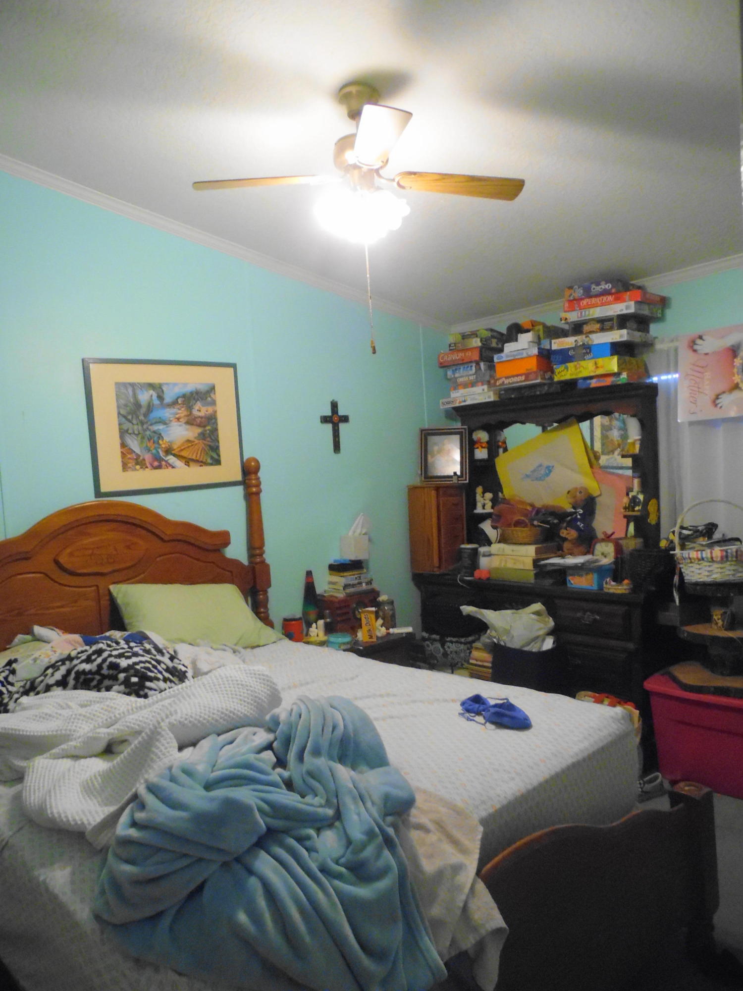 642 Elmwood Road DeFuniak Springs, FL 32433 - Photo 29 of 37 a bedroom with a bed and a chandelier