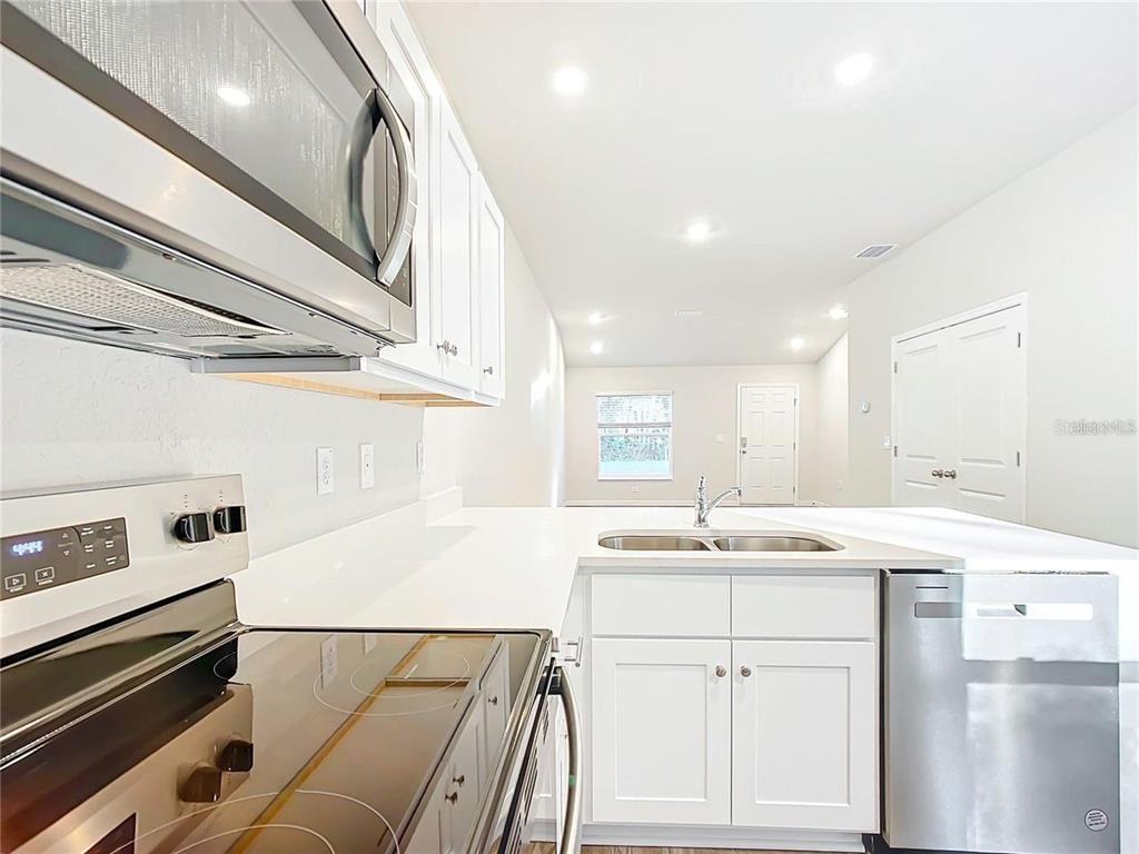 3070 East Odier Street Inverness, FL 34453 - Photo 4 of 14 a kitchen with a sink cabinets and window