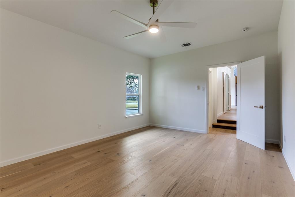 4371 Mill Creek Road Dallas, TX 75244 - Photo 17 of 33 an empty room with wooden floor and windows