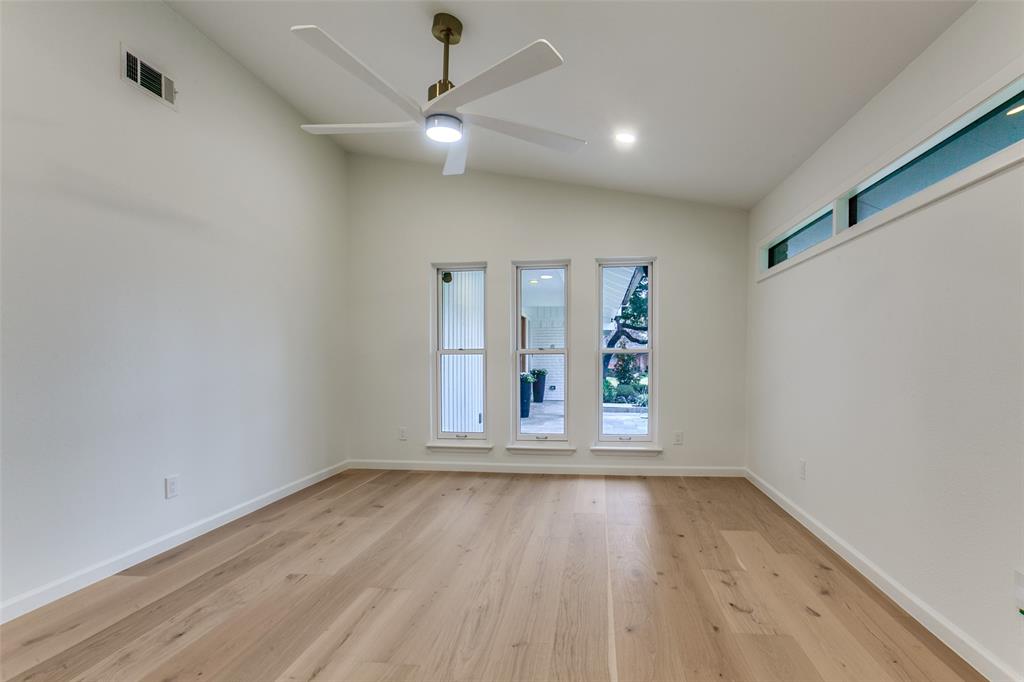4371 Mill Creek Road Dallas, TX 75244 - Photo 20 of 33 an empty room with wooden floor fan and window
