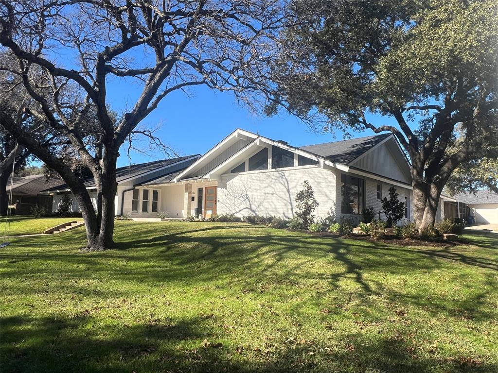 4371 Mill Creek Road Dallas, TX 75244 - Photo 2 of 33 a white house with a big yard and large trees
