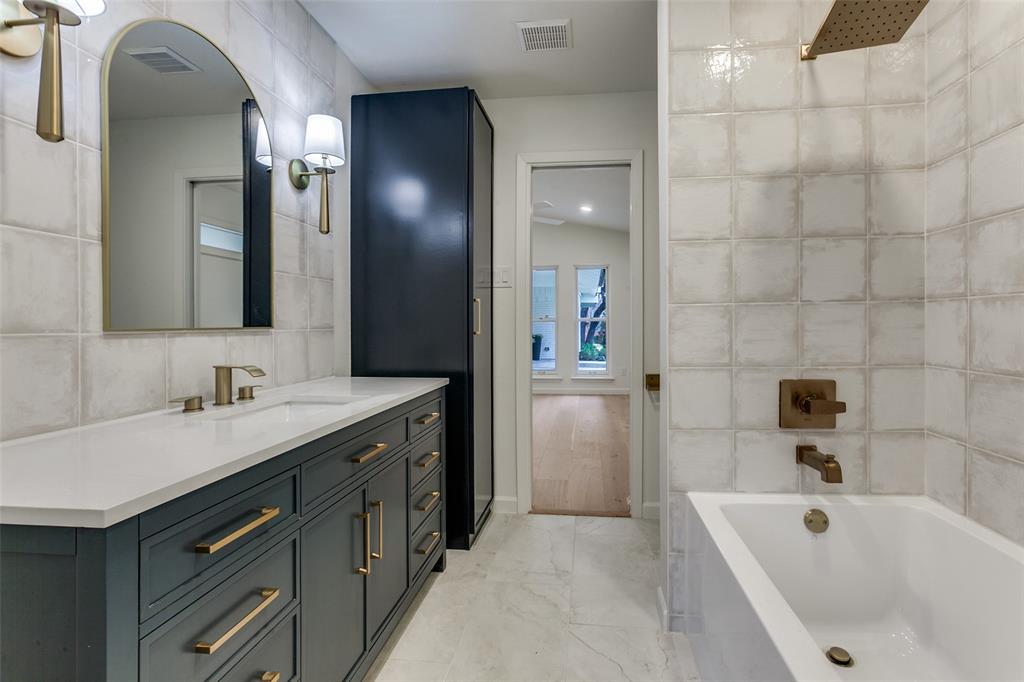 4371 Mill Creek Road Dallas, TX 75244 - Photo 21 of 33 a bathroom with a tub sink and mirror