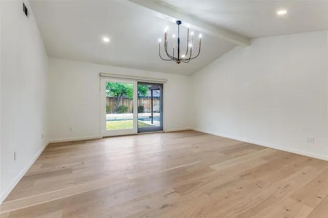 a bathroom with a double vanity sink a mirror and a bathtub