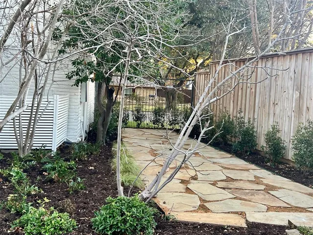 a view of a backyard with pathway