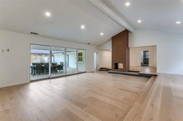 an empty room with floor to ceiling window and windows