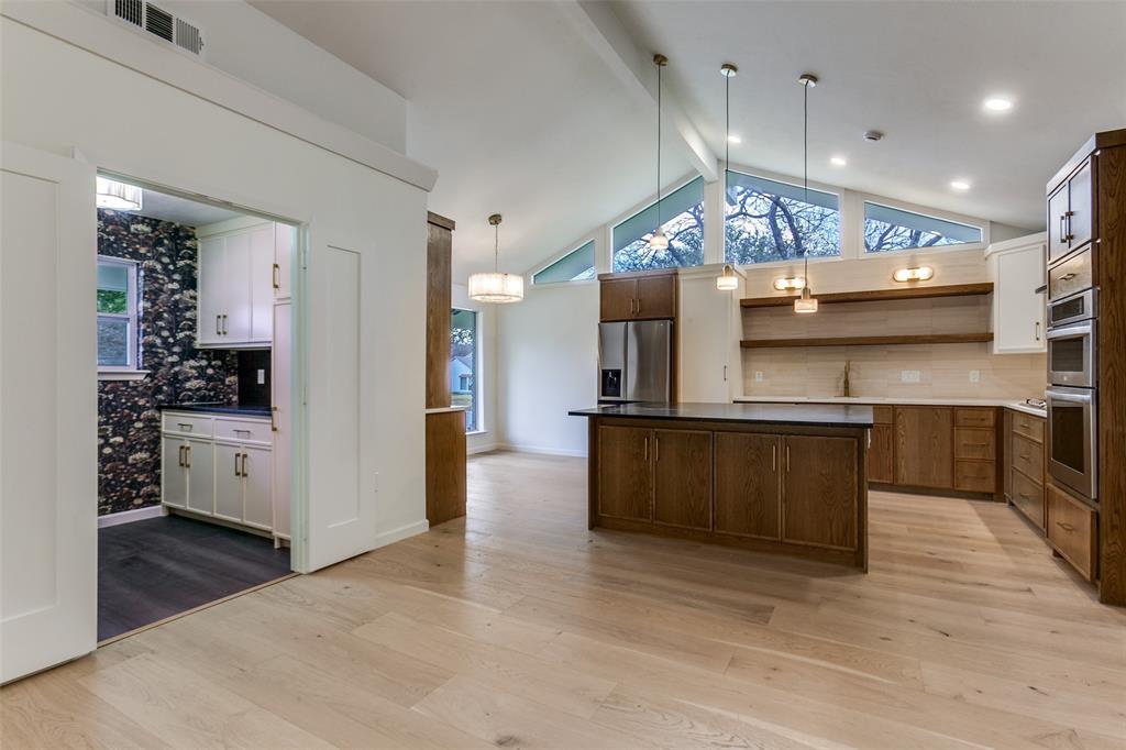 4371 Mill Creek Road Dallas, TX 75244 - Photo 8 of 33 a large kitchen with stainless steel appliances kitchen island a large counter space a sink and a refrigerator