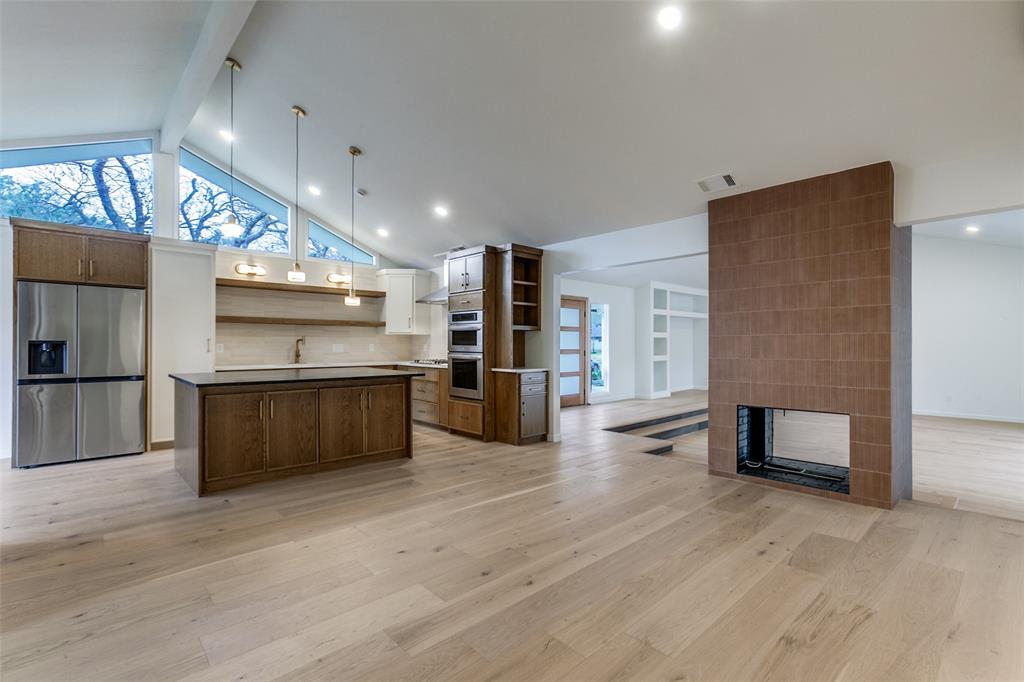 4371 Mill Creek Road Dallas, TX 75244 - Photo 9 of 33 a kitchen with stainless steel appliances kitchen island granite countertop a refrigerator and a stove top oven