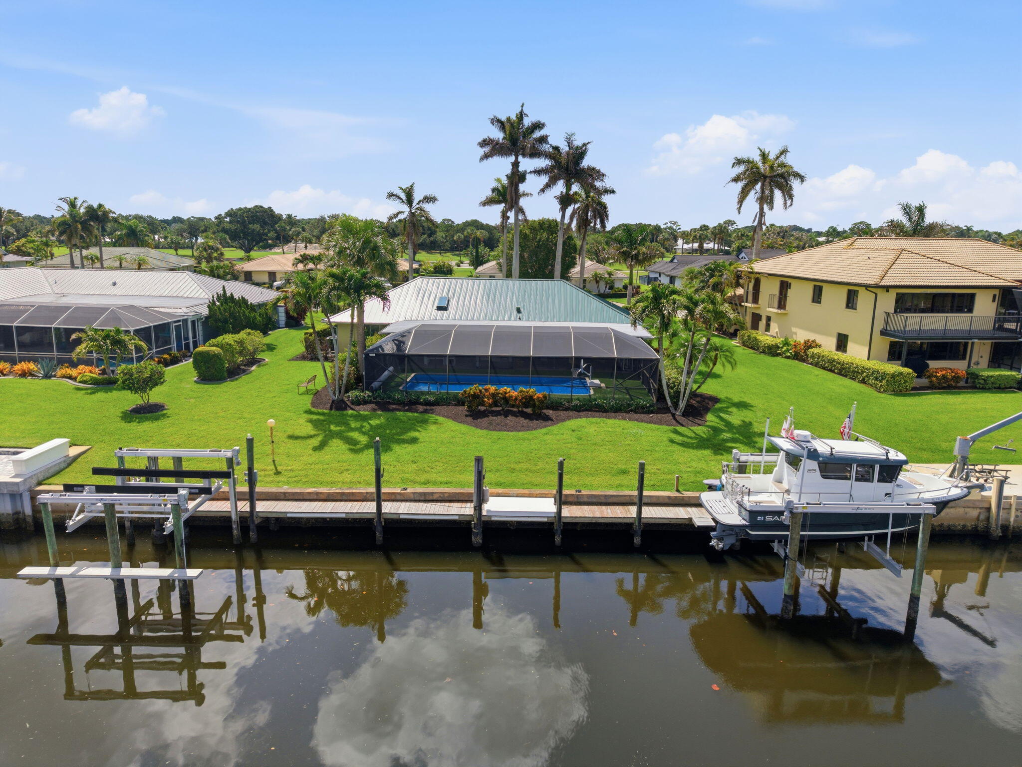 3374 Southeast Fairway East Stuart, FL 34997 - Photo 1 of 65 a view of a lake with a table and chairs under an umbrella