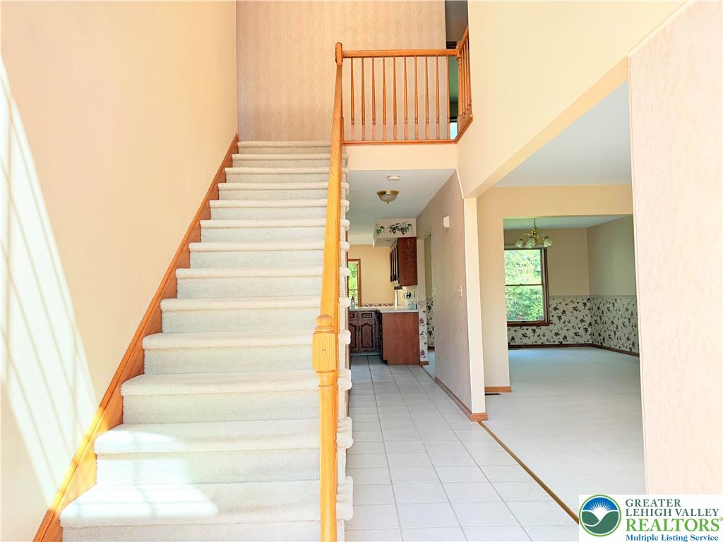 4165 Alder Road Bethlehem, PA 18020 - Photo 5 of 42 a view of a hallway to a livingroom with wooden floor and stairs