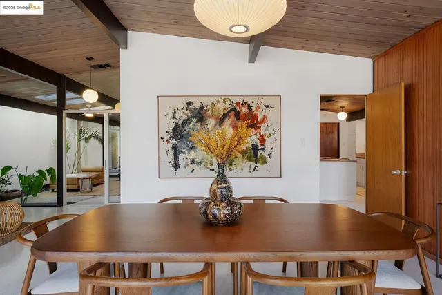 a view of a patio with table and chairs and potted plants