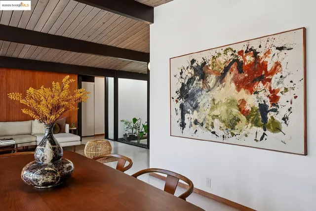 a view of a living room and floor to ceiling window and wooden floor