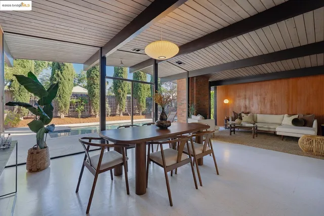 a view of a patio with a table and chairs and potted plants