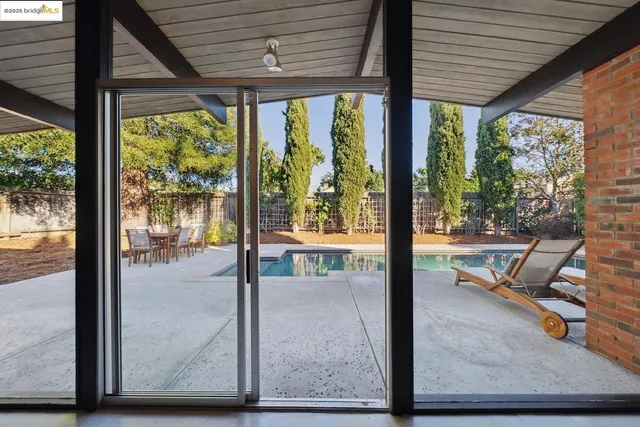 a view of a chairs and table in the patio