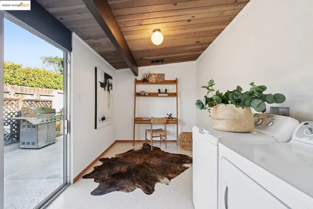 a view of a hallway with wooden floor and a living room