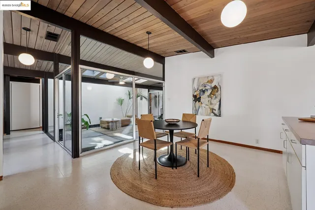 a bedroom with furniture and a large window