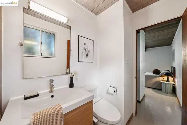 a bedroom with bed and a window