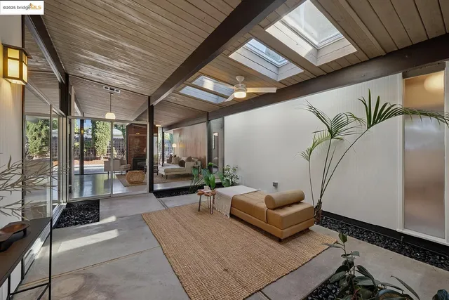 a outdoor space with lots of furniture and white walls