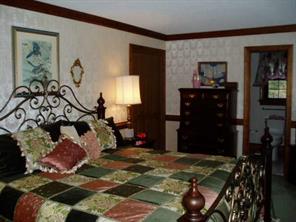 4303 Plateau Road Newton, NC 28658 - Photo 4 of 9 a bedroom with a bed and a mirror on dresser