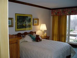 4303 Plateau Road Newton, NC 28658 - Photo 5 of 9 a bedroom with a bed and a painting on the wall
