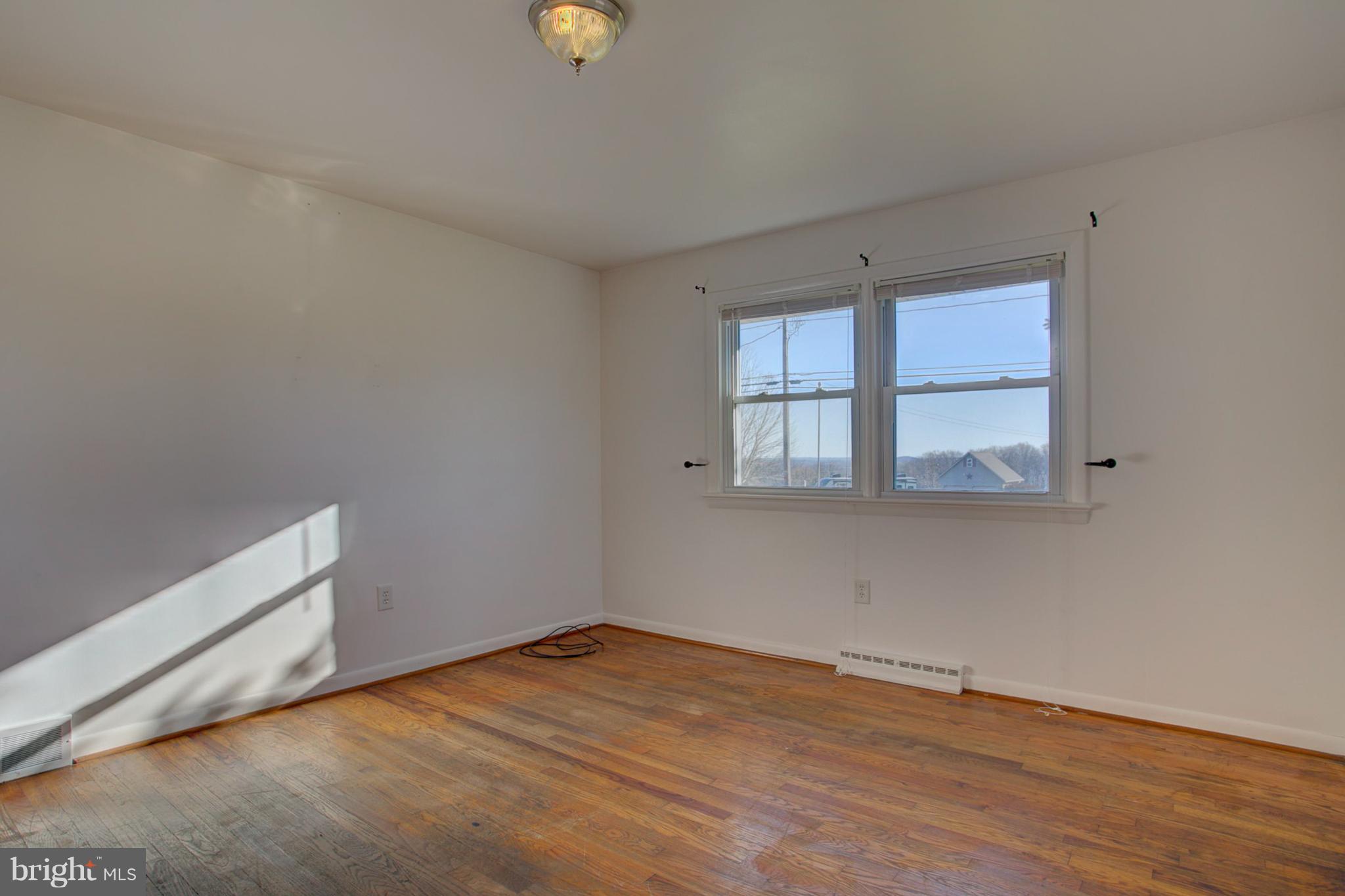 1047 Letort Road Conestoga, PA 17516 - Photo 18 of 30 an empty room with wooden floor and windows
