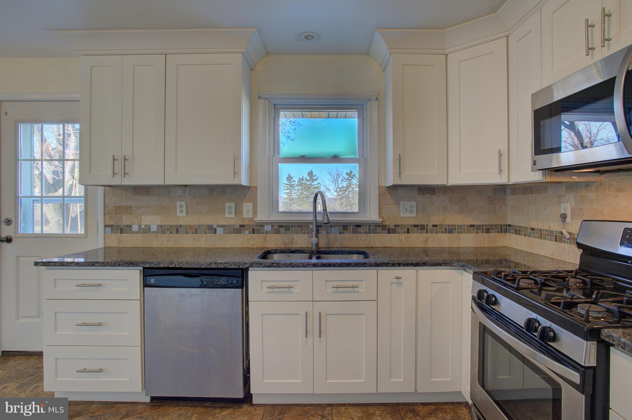 1047 Letort Road Conestoga, PA 17516 - Photo 8 of 30 a kitchen with cabinets appliances a sink and a window