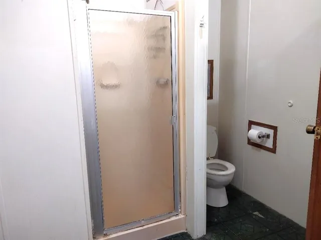 a bathroom with a toilet a sink and a shower