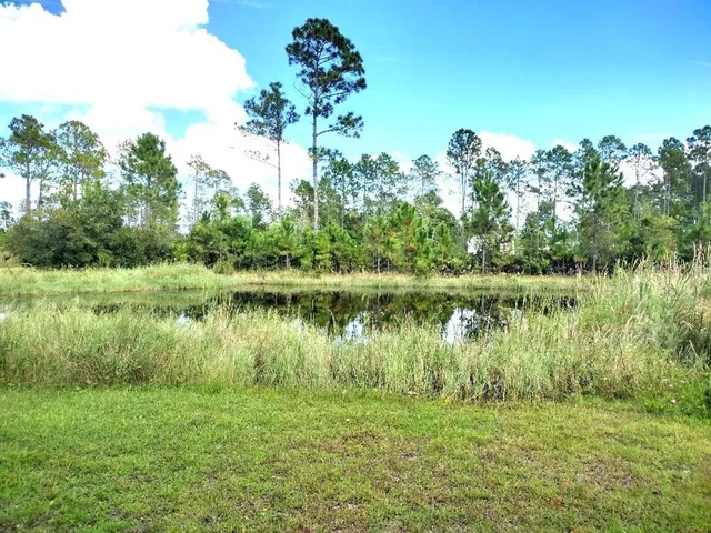 a view of a lake with a yard