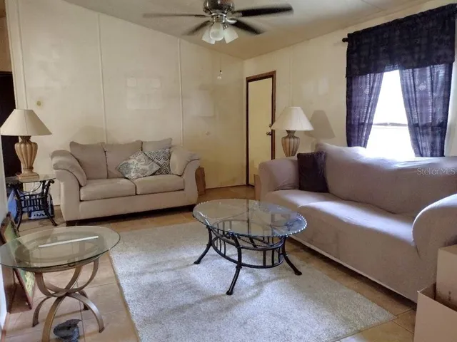 a living room with furniture and a large window