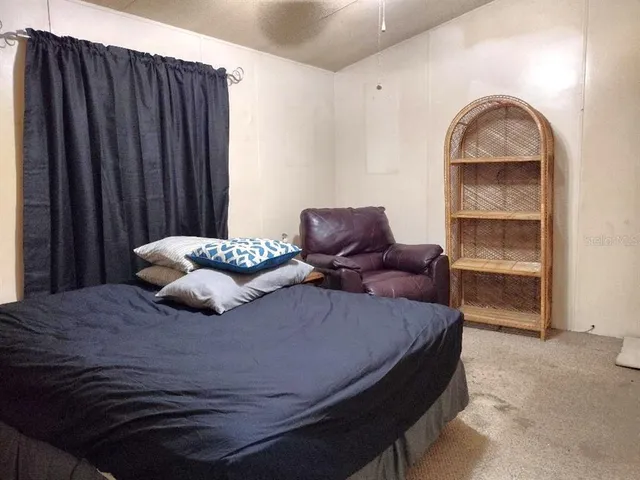 a bedroom with a bed and a cabinet