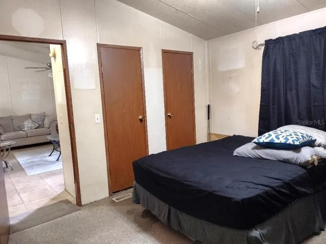 a bedroom with a bed and a mirror