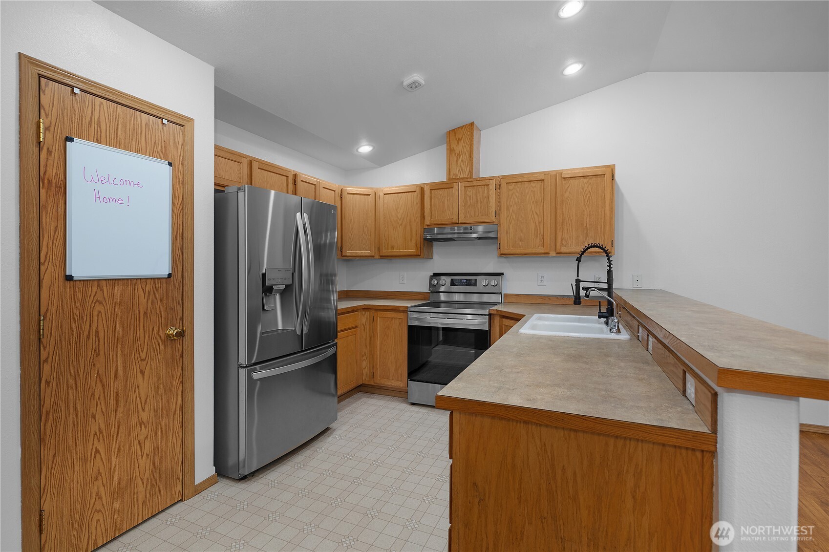7606 187th Avenue Southwest Rochester, WA 98579 - Photo 10 of 28 a kitchen with a refrigerator and a sink