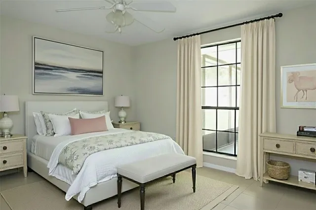 a bedroom with a bed and a chandelier