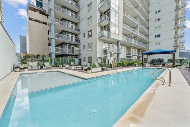 a swimming pool with outdoor seating and yard