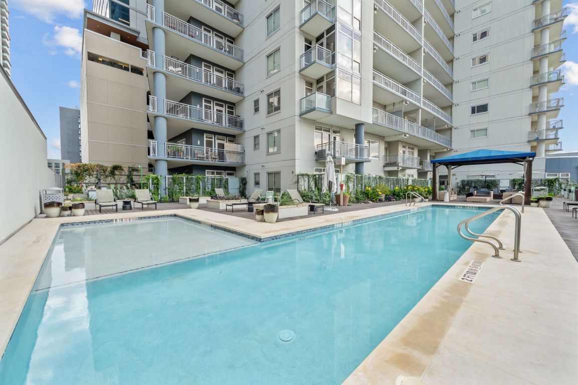 603 Davis Street, Unit 710 Austin, TX 78701 - Photo 1 of 37 a swimming pool with outdoor seating and yard