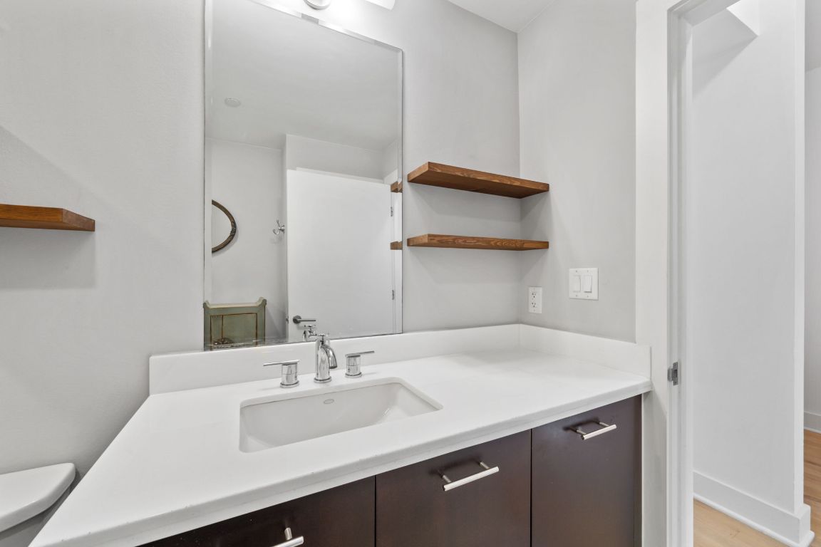 603 Davis Street, Unit 710 Austin, TX 78701 - Photo 13 of 37 a bathroom with a sink and a mirror
