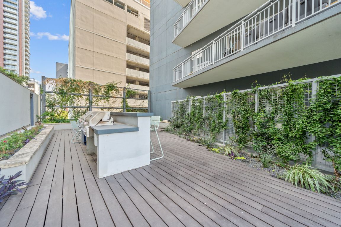 603 Davis Street, Unit 710 Austin, TX 78701 - Photo 20 of 37 a balcony with wooden floor and fence