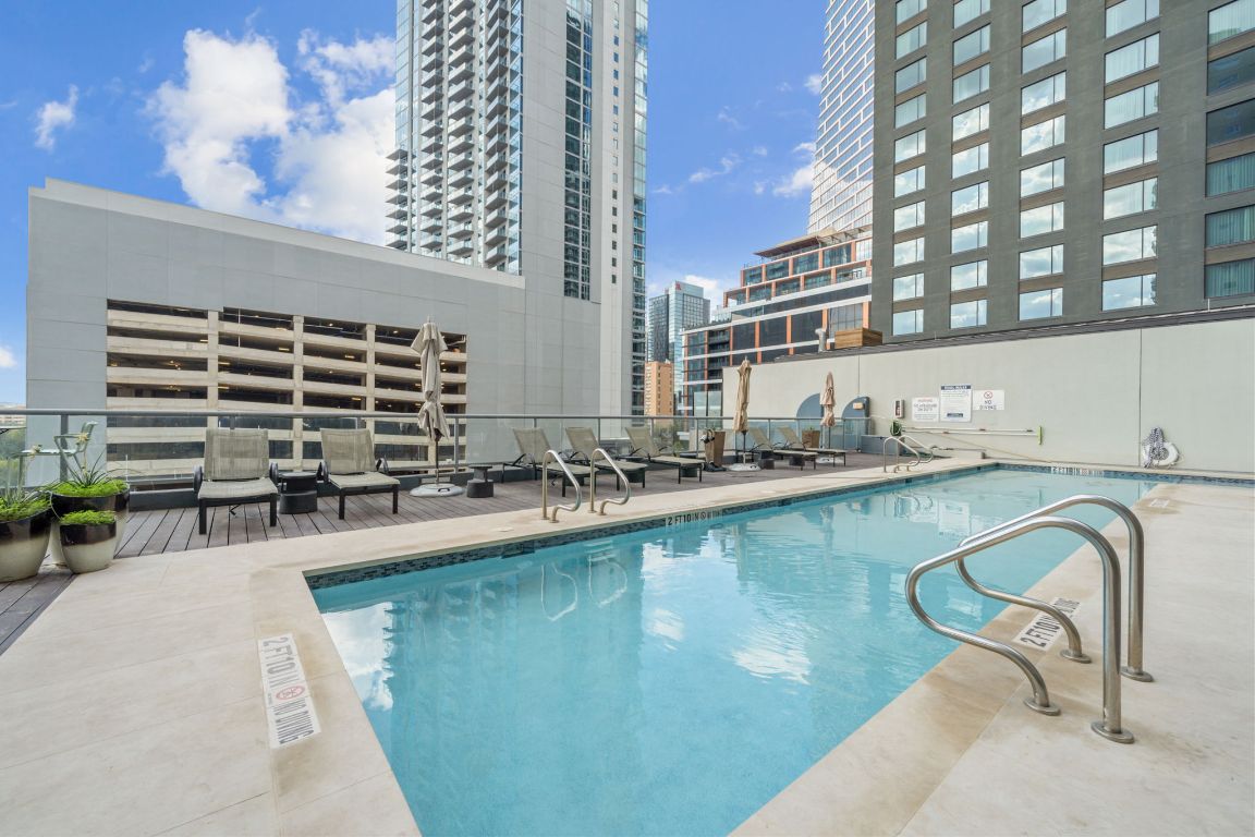 603 Davis Street, Unit 710 Austin, TX 78701 - Photo 22 of 37 a kitchen with a sink a table and chairs