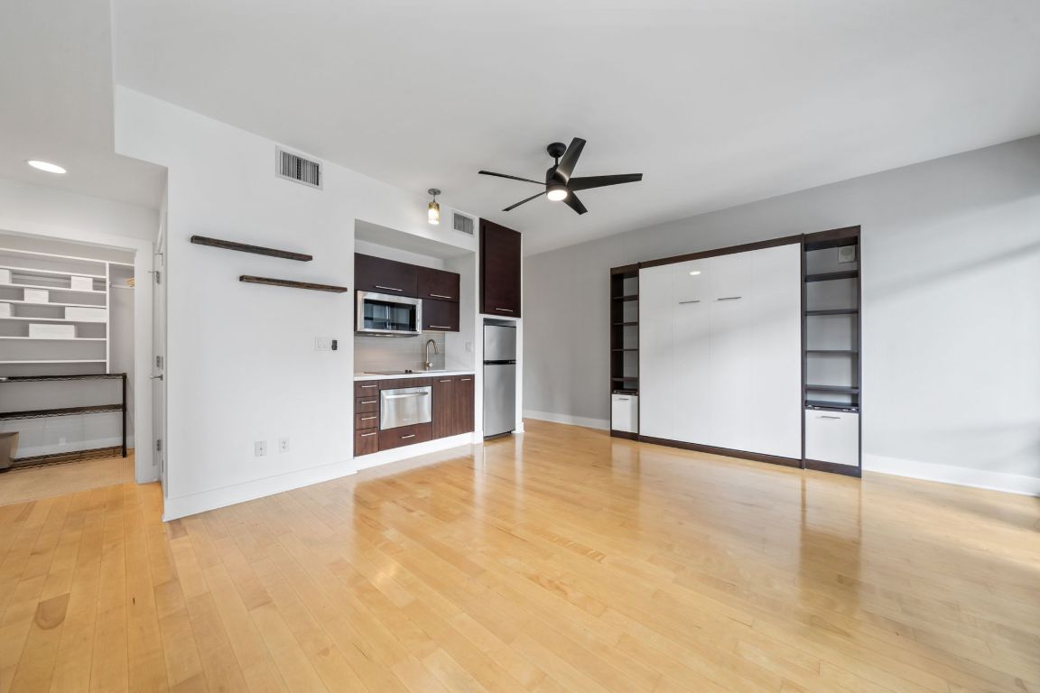 603 Davis Street, Unit 710 Austin, TX 78701 - Photo 4 of 37 a view of a kitchen with an empty room and fire place
