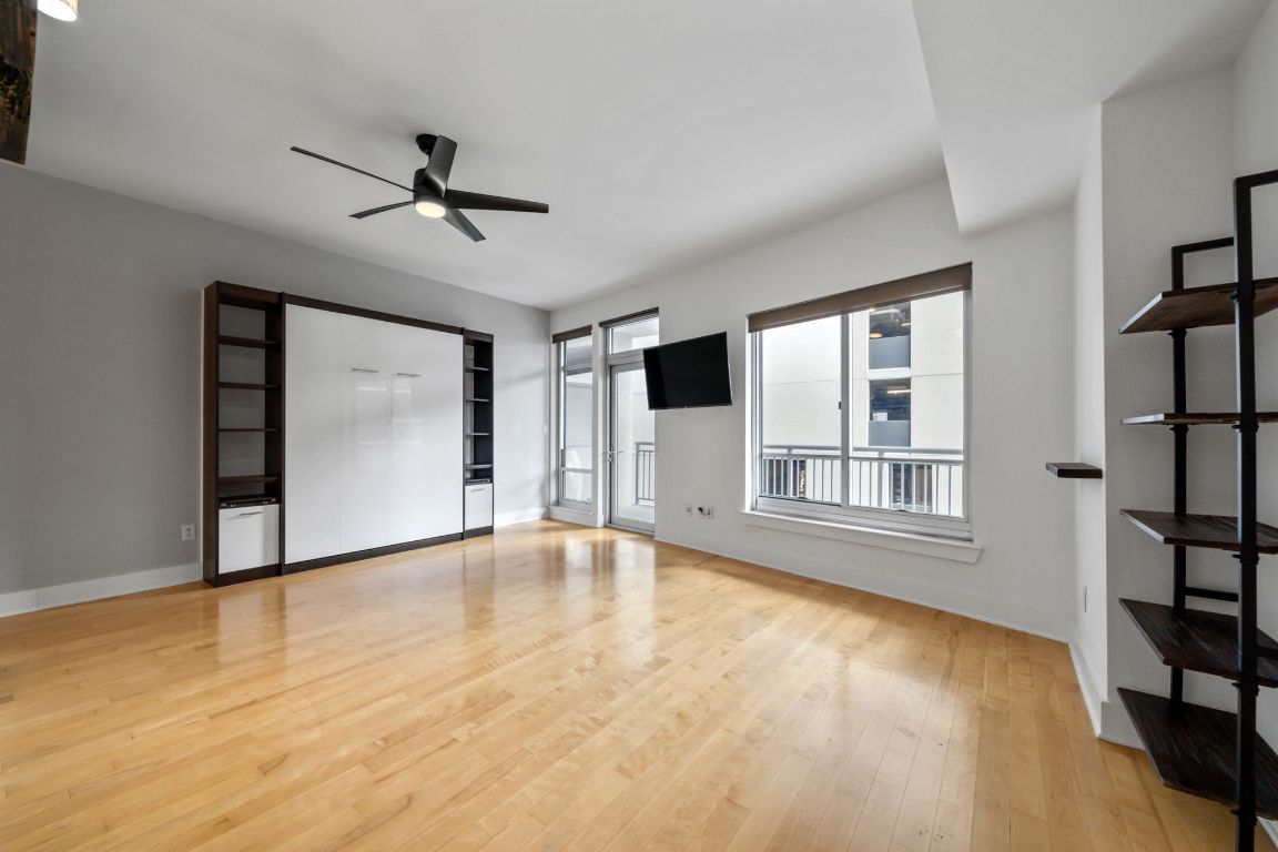 603 Davis Street, Unit 710 Austin, TX 78701 - Photo 6 of 37 a view of an empty room with a window and wooden floor