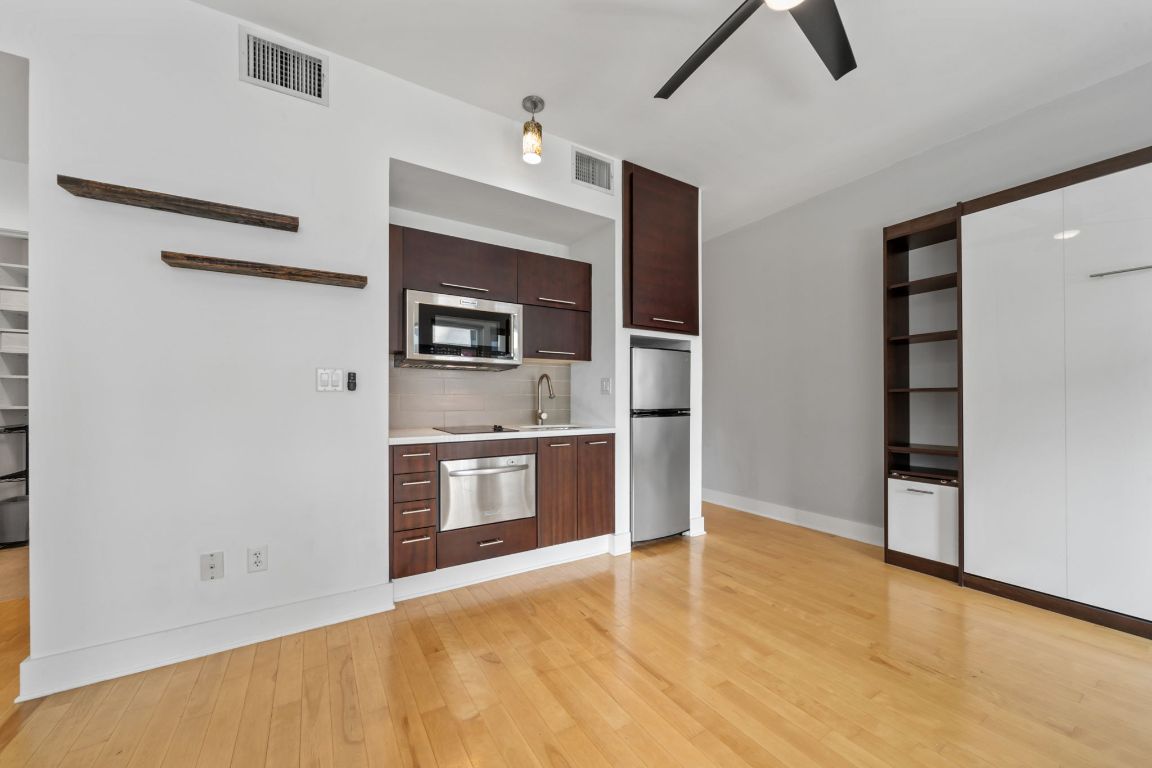 603 Davis Street, Unit 710 Austin, TX 78701 - Photo 8 of 37 a view of kitchen with stainless steel appliances wooden floor and window