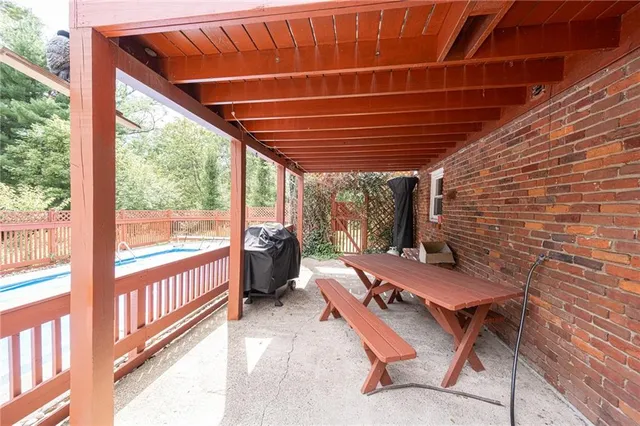 a view of a porch with furniture and wooden floor