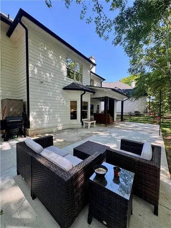a front view of a house with swimming pool and sitting area