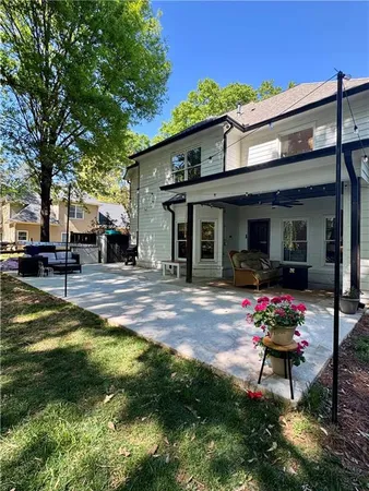 a backyard of a house with table and chairs