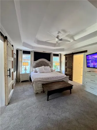a bedroom with a bed and a ceiling fan